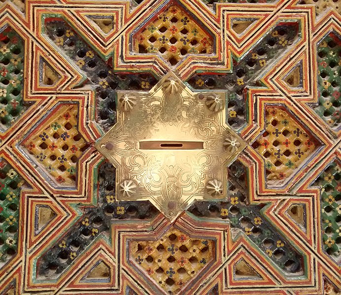 A slot for giving zakat at the Zaouia Moulay Idriss II in Fez, Morocco.